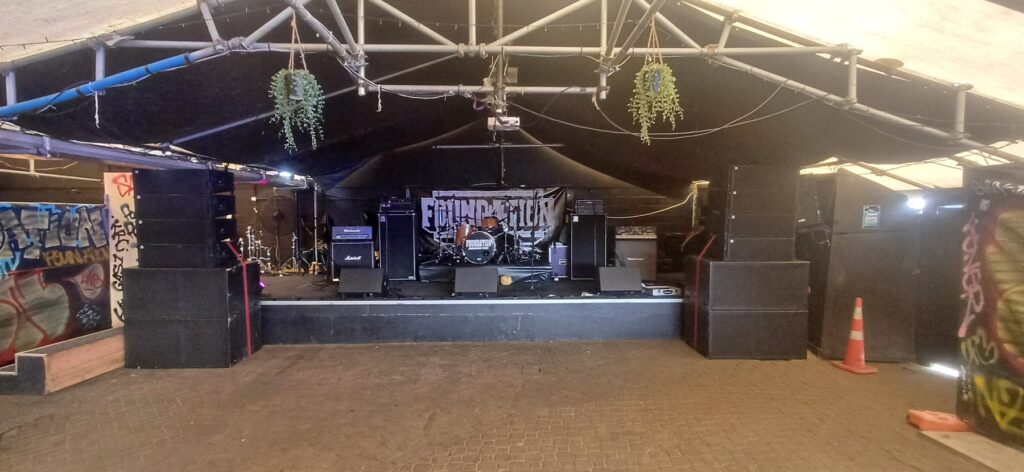 Line array PA stacks either side of a venue stage ready for a show